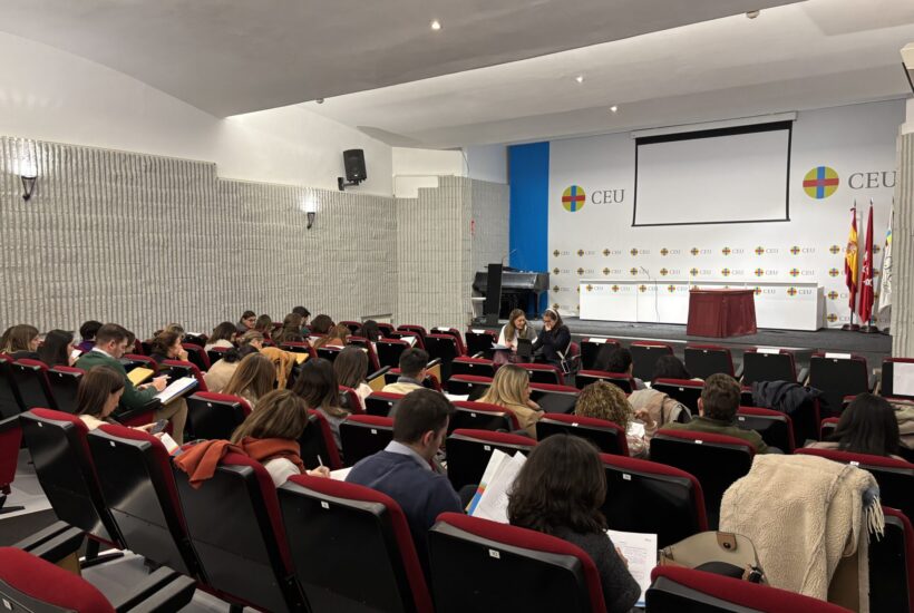 a group of people sitting in a lecture hall